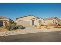 Single-story house with a two-car garage and desert landscaping at 6411 Ranunculus St, North Las Vegas, NV 89084