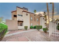 Tan two-story building with walkway and landscaping; shows multiple units at 2986 Juniper Hills Blvd # 204, Las Vegas, NV 89142