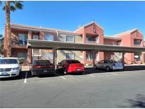 Exterior view of apartment building parking lot with covered spaces at 4730 E Craig Rd # 1134, Las Vegas, NV 89115