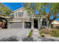 Two-story house exterior with landscaping and a tree at 10218 Rockridge Peak Ave, Las Vegas, NV 89166