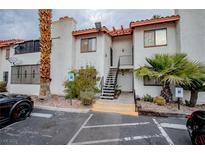 Spanish style condo building with parking and landscaping at 1701 E Katie Ave # 72, Las Vegas, NV 89119