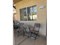 Small patio with table and chairs, perfect for relaxing outdoors at 5250 S Rainbow Blvd # 1176, Las Vegas, NV 89118