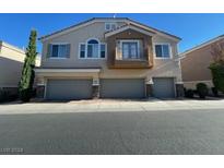 Tan three-story townhouse with three-car garage and balcony at 8679 Tom Noon Ave # 102, Las Vegas, NV 89178