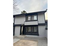 Two-story townhouse with gray exterior, dark trim, and small front yard at 3505 Mercury St # G, North Las Vegas, NV 89030