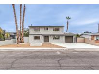 Remodeled two-story house with landscaped front yard and driveway at 5520 Morendo Dr, Las Vegas, NV 89107