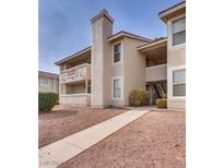 Tan two-story building with walkway and landscaping at 7300 Pirates Cove Rd # 1087, Las Vegas, NV 89145
