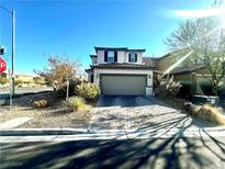 Two-story house with attached garage and landscaped front yard at 9306 Colinton Ct, Las Vegas, NV 89178