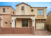 Two-story stucco home with attached garage and landscaped yard at 9704 Villa Lorena Ave, Las Vegas, NV 89147