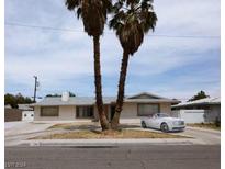 Single story home with palm trees and a driveway at 2186 Siesta Ave, Las Vegas, NV 89169