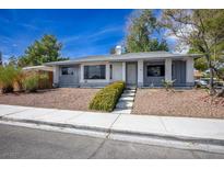 Single-story home with gray accents, landscaping, and a paved walkway at 3609 Woodglen Ct, Las Vegas, NV 89108