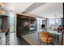Modern living room with city views, fireplace, and ample seating at 4381 W Flamingo Rd # 2202, Las Vegas, NV 89103
