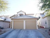 Two-story house with a two-car garage and landscaped front yard at 7563 Durham Hall Ave # 101, Las Vegas, NV 89130