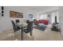 Bright dining area with glass table and four black chairs at 270 E Flamingo Rd # 106, Las Vegas, NV 89169
