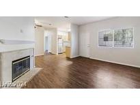 Living room with fireplace and wood-look floors at 5250 S Rainbow Blvd # 2115, Las Vegas, NV 89118