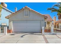 Cute one-story house with a two-car garage and landscaped front yard at 1950 Turtlerock St, Las Vegas, NV 89142