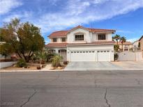 Two-story house with a three-car garage and landscaping at 3049 Azure Bay St, Las Vegas, NV 89117