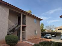 Tan two-story building with stairs and landscaping at 5576 W Rochelle Ave # 40D, Las Vegas, NV 89103