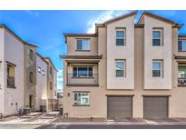 Two-story townhome with attached garage and modern exterior at 2657 Champagne Gold Ave, North Las Vegas, NV 89086