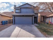 Two-story house with gray siding, attached garage, and a small yard at 4197 Tolkien, Las Vegas, NV 89115