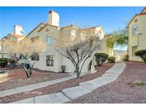 Spanish style condo building with walkway and landscaping at 698 S Racetrack Rd # 1621, Henderson, NV 89015