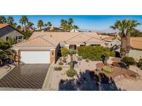 Single-story house with desert landscaping and a tile driveway at 11008 Mission Lakes Ave, Las Vegas, NV 89134