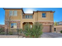 Two-story house with balcony, stone accents, and a landscaped front yard at 2815 Athens Ridge Dr, Henderson, NV 89052