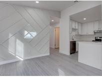 Modern kitchen with white cabinets, stainless steel appliances, and quartz countertops at 4432 Halbert Ave, Las Vegas, NV 89110