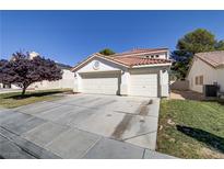 Two-story house with a three-car garage and mature landscaping at 6086 Shadow Oak Dr, North Las Vegas, NV 89031