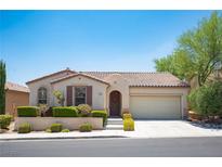 Single-story house with tan exterior, brown roof, and landscaped front yard at 9343 Oxbow Lake Ave, Las Vegas, NV 89149