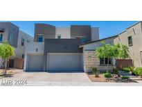 Modern two-story house with attached two-car garage and landscaped front yard at 2169 Radiant Horizon Ave, Henderson, NV 89052