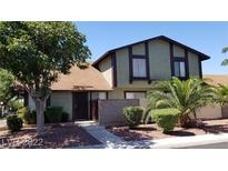 Two-story townhouse with a brown door and landscaped yard at 4501 Buena Vista Dr, Las Vegas, NV 89102