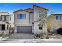 Two-story house with gray exterior, gray garage door, and a paved driveway at 15 Santo Mio Ct, Henderson, NV 89011