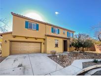 Two-story house with teal shutters, attached garage, and landscaped yard at 2305 Statham Ave, North Las Vegas, NV 89081