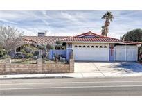 Single story home with red tile roof, attached garage, and landscaped front yard at 3778 Spitze Dr, Las Vegas, NV 89103