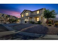 Two-story house with a three-car garage and landscaped yard at dusk at 6491 Bristle Canyon Ave, Las Vegas, NV 89110