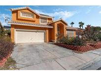 Two-story house with solar panels, landscaped yard, and attached garage at , North Las Vegas, NV 89031