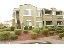 Tan two-story building with landscaping and parking at 9303 Gilcrease Ave # 2164, Las Vegas, NV 89149