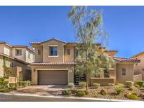 Two-story house with tan exterior, brown garage door, and landscaped yard at 12048 Portamento Ct, Las Vegas, NV 89138