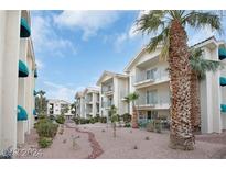 Two-story condo building with palm trees and desert landscaping at 3550 Bay Sands Dr # 3064, Laughlin, NV 89029