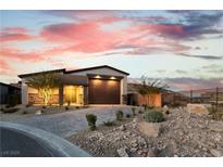 Single-story home with a large garage and landscaped front yard at 9570 Thistle Creek Ave, Las Vegas, NV 89178