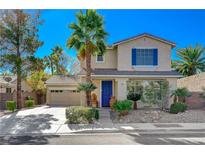 Two-story house with blue shutters, landscaping, and a two-car garage at 2383 Falsetto Ave, Henderson, NV 89052