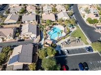 Aerial view of community pool, playground, and surrounding homes at 6040 Emma Bay Ct # 101, North Las Vegas, NV 89031